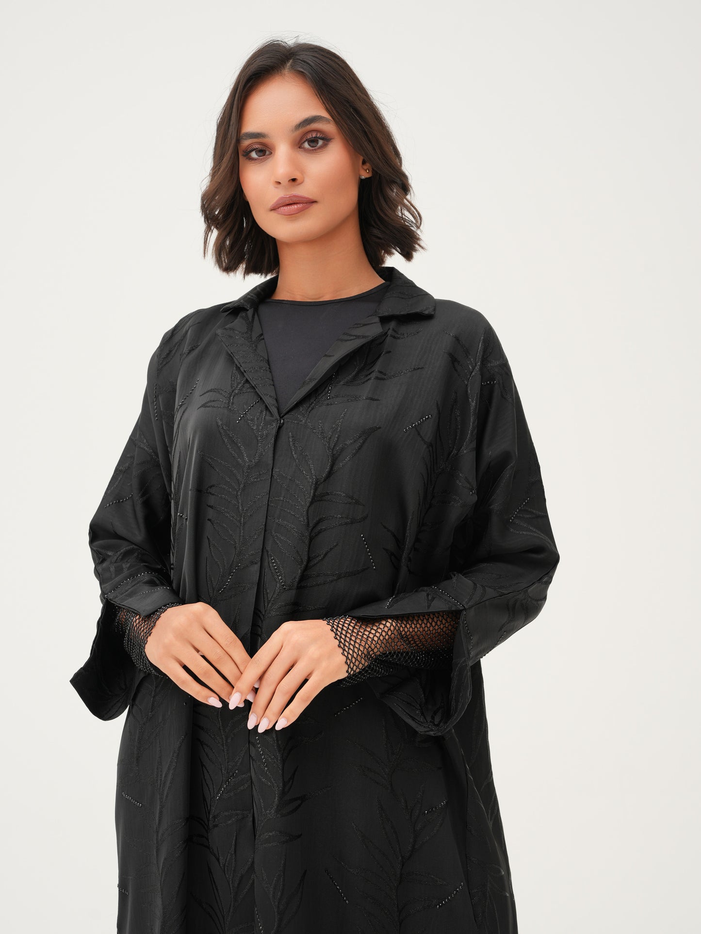 Collared abaya with textured fabric and delicate net detailing on the cuffs