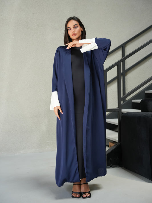 Collared abaya features off-white fabric and button details on the sleeves