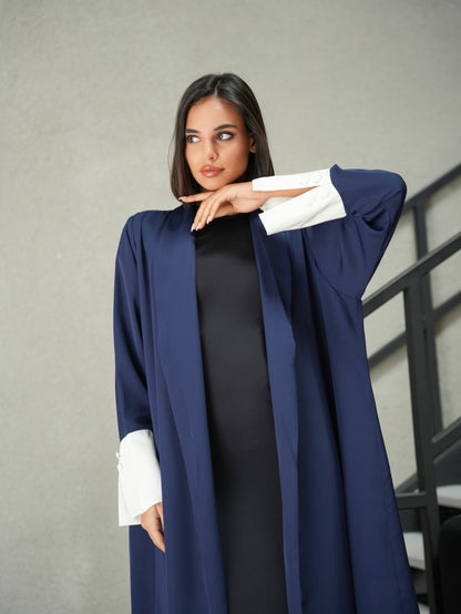 Collared abaya features off-white fabric and button details on the sleeves