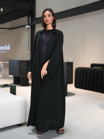 Collared abaya features slitted sleeves and covered button details