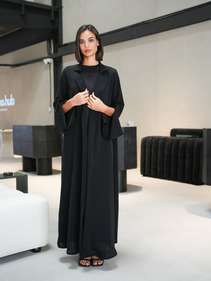 Collared abaya features slitted sleeves and covered button details